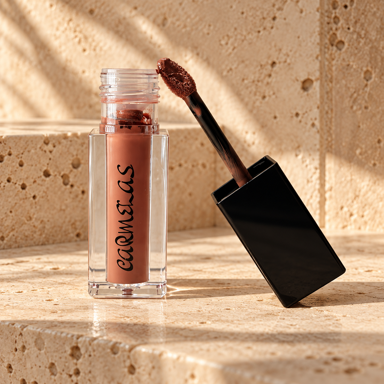 Carmelas Rodeo Dust matte liquid lipstick in a beige vanity setting